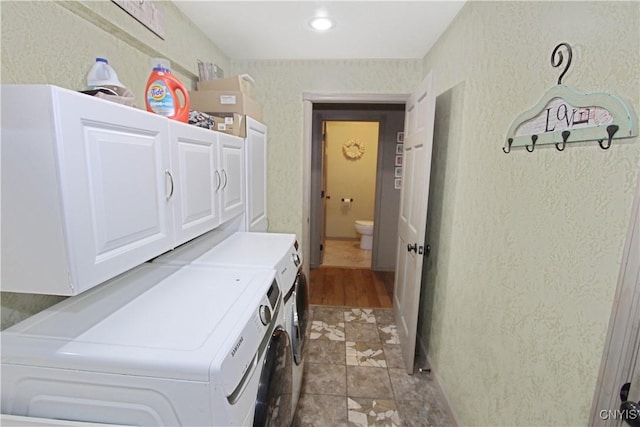 7030 Peckham Rd, Watson, NY 13367 - laundry room featuring cabinet space, washing machine and dryer, and a textured wall