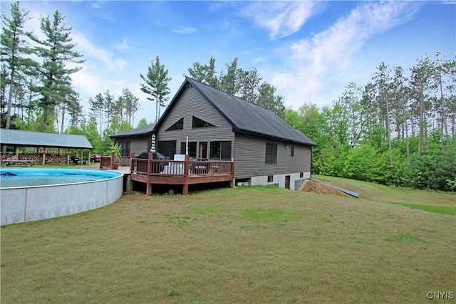 7030 Peckham Rd, Watson, NY 13367 - back of house featuring an outdoor pool, a wooden deck, and a yard