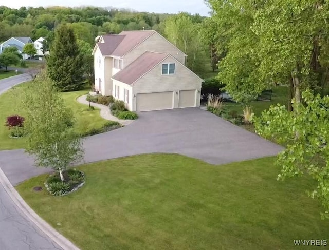 7899 E Ridge Pointe Dr, Manlius, NY 13066 - view of side of property with asphalt driveway, a lawn, and a garage