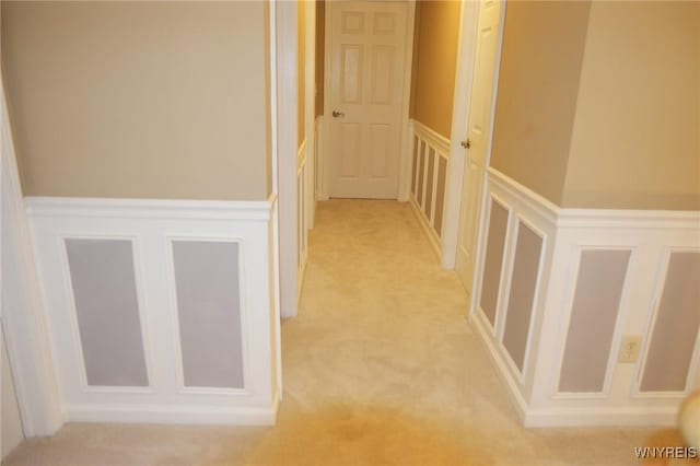 7899 E Ridge Pointe Dr, Manlius, NY 13066 - corridor with a decorative wall, a wainscoted wall, and light colored carpet