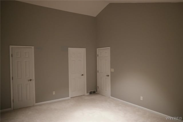 7899 E Ridge Pointe Dr, Manlius, NY 13066 - empty room featuring light colored carpet, lofted ceiling, and baseboards