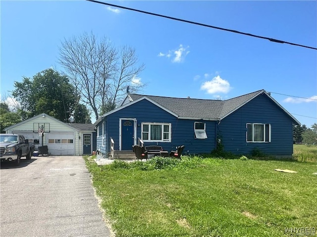 2746 Johnson Creek Rd, Hartland, NY 14105 - ranch-style home with a front lawn, an outdoor structure, a detached garage, and roof with shingles