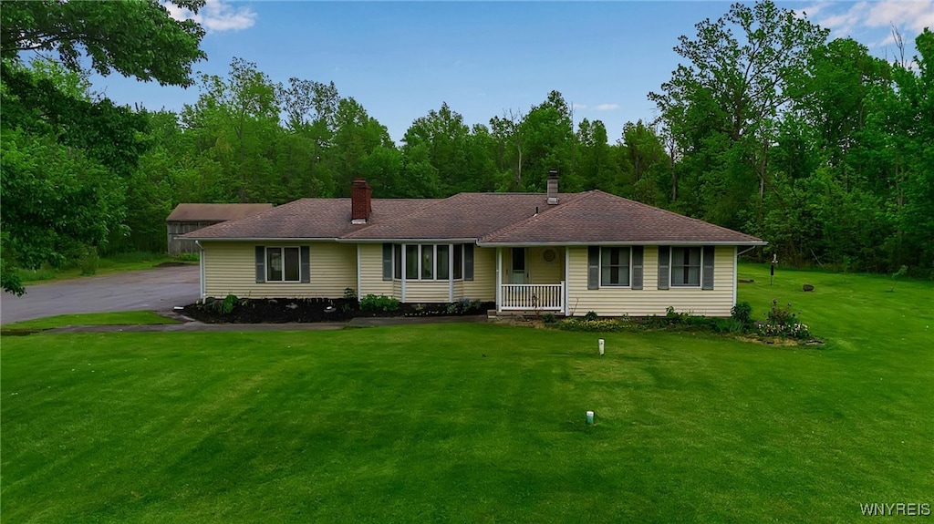 4995 Millersport Hwy, Amherst, NY 14051 - ranch-style home with a front yard, covered porch, and a chimney
