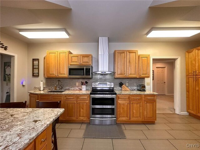 10 Foery Dr Unit 404, Utica, NY 13501 - kitchen featuring stainless steel appliances, a sink, wall chimney range hood, and decorative backsplash