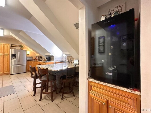 10 Foery Dr Unit 404, Utica, NY 13501 - dining space featuring a bar and light tile patterned flooring