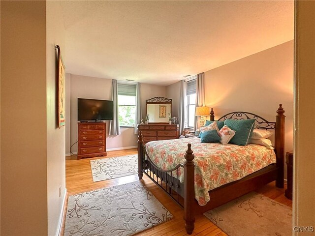 10 Foery Dr Unit 404, Utica, NY 13501 - bedroom featuring light wood-style flooring and baseboards