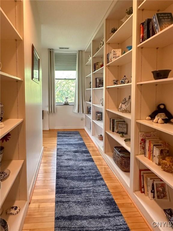 10 Foery Dr Unit 404, Utica, NY 13501 - hallway featuring light wood-style flooring and baseboards