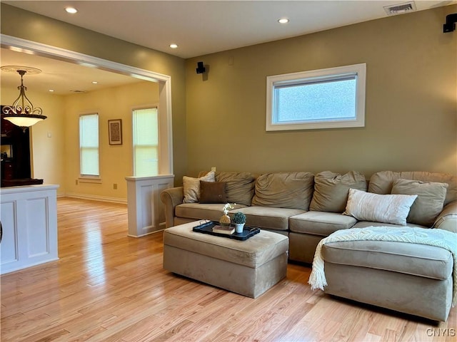 living area with light wood-style floors, recessed lighting, and baseboards