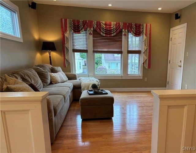 living area featuring light wood-style flooring and recessed lighting