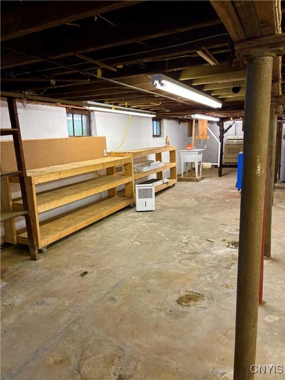 unfinished basement featuring a workshop area and a sink