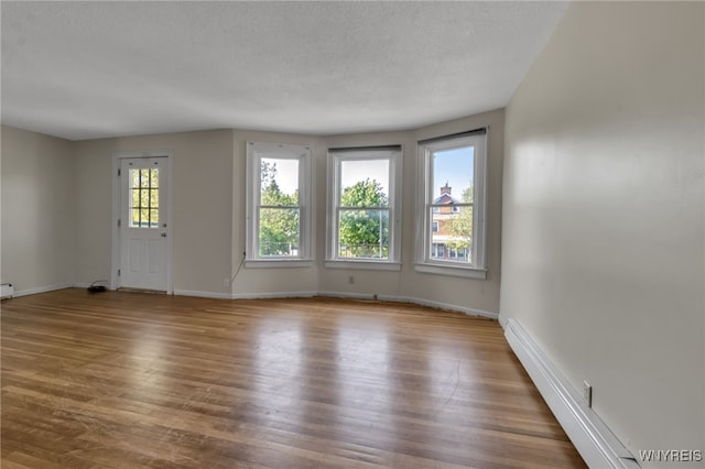 1681 Amherst St, Buffalo, NY 14214 - unfurnished living room with baseboards and wood finished floors