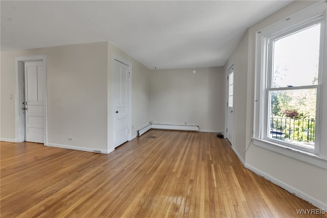 1681 Amherst St, Buffalo, NY 14214 - unfurnished room with light wood-style floors, plenty of natural light, a baseboard radiator, and baseboards