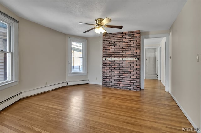 1681 Amherst St, Buffalo, NY 14214 - spare room featuring light wood-style flooring, ceiling fan, brick wall, a textured ceiling, and baseboard heating