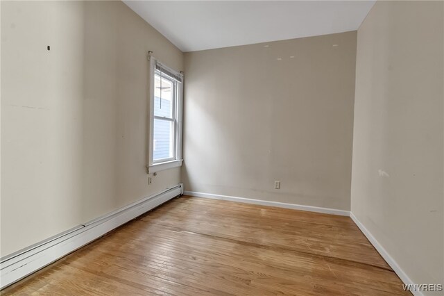 1681 Amherst St, Buffalo, NY 14214 - unfurnished room featuring a baseboard heating unit, light wood-style floors, and baseboards
