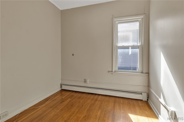1681 Amherst St, Buffalo, NY 14214 - empty room featuring a baseboard radiator, hardwood / wood-style floors, baseboards, and ornamental molding