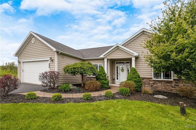 146 Edwards Falls Ln, Manlius, NY 13104 - view of front facade featuring an attached garage, a front lawn, stone siding, and driveway