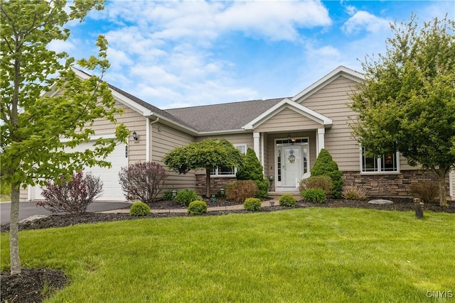 146 Edwards Falls Ln, Manlius, NY 13104 - view of front of home featuring stone siding, a front lawn, an attached garage, and driveway