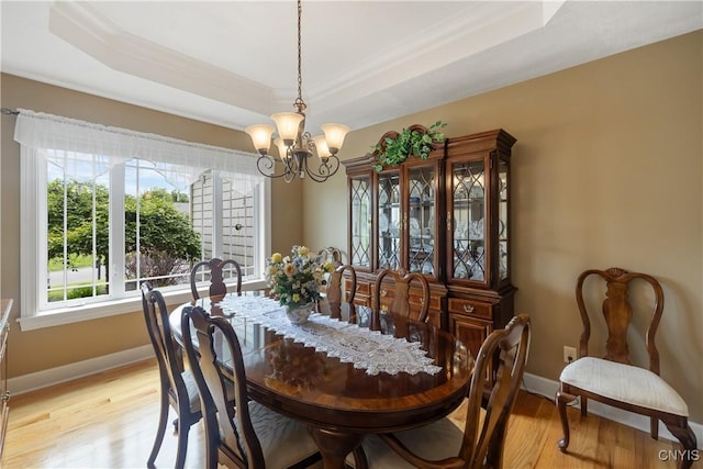 146 Edwards Falls Ln, Manlius, NY 13104 - dining area with a raised ceiling, a chandelier, light wood-style flooring, baseboards, and ornamental molding