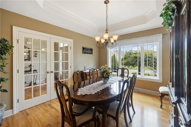 146 Edwards Falls Ln, Manlius, NY 13104 - dining area with french doors, a raised ceiling, a chandelier, ornamental molding, and light wood finished floors