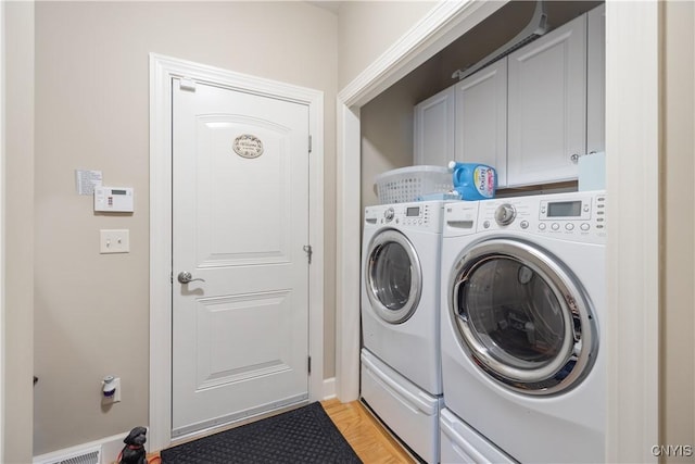 146 Edwards Falls Ln, Manlius, NY 13104 - laundry room featuring washing machine and clothes dryer, cabinet space, baseboards, and light wood finished floors