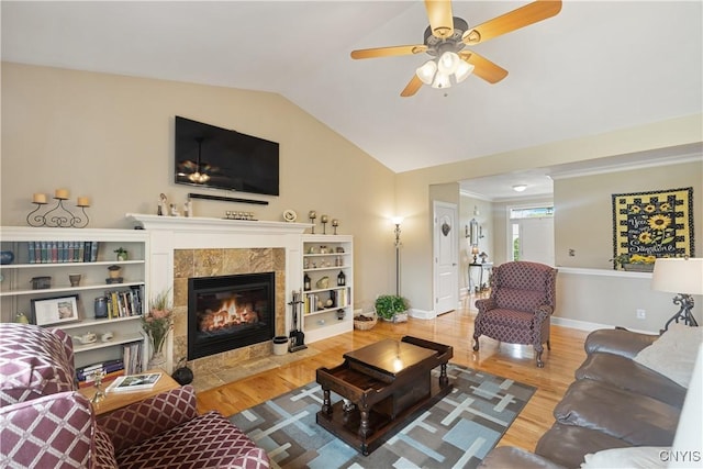 146 Edwards Falls Ln, Manlius, NY 13104 - living area featuring lofted ceiling, a tile fireplace, baseboards, wood finished floors, and ceiling fan