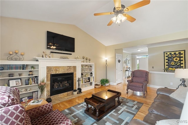 146 Edwards Falls Ln, Manlius, NY 13104 - living area with lofted ceiling, wood finished floors, baseboards, a tiled fireplace, and ceiling fan