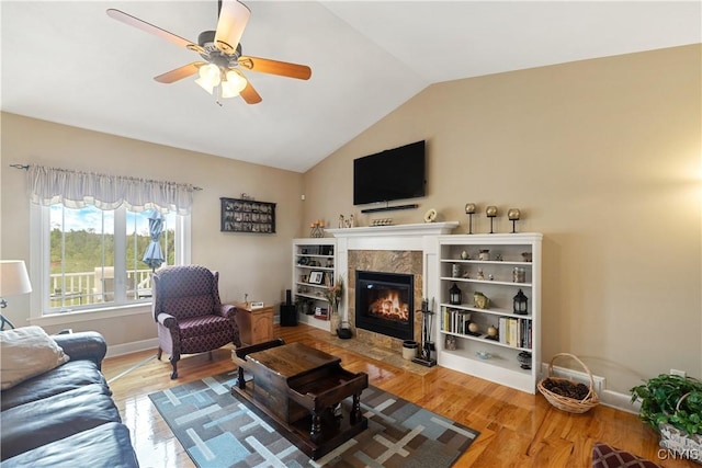 146 Edwards Falls Ln, Manlius, NY 13104 - living room featuring a tiled fireplace, a ceiling fan, wood finished floors, vaulted ceiling, and baseboards