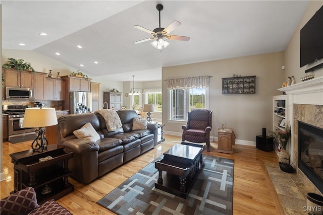 146 Edwards Falls Ln, Manlius, NY 13104 - living room featuring a fireplace, ceiling fan, light wood-style flooring, lofted ceiling, and baseboards