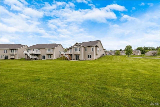 146 Edwards Falls Ln, Manlius, NY 13104 - back of house featuring a residential view, stairway, a yard, and a deck