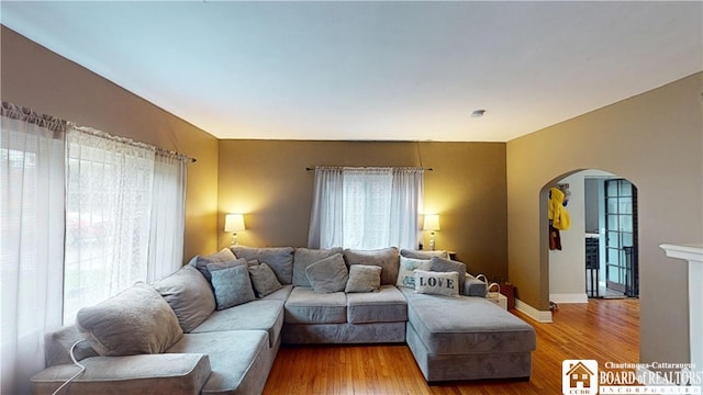 3108 N Main Street Ext, Ellicott, NY 14701 - living room with arched walkways, wood finished floors, and baseboards
