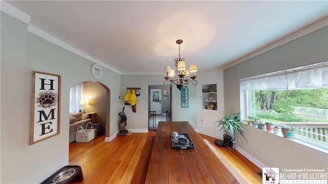 3108 N Main Street Ext, Ellicott, NY 14701 - dining area featuring arched walkways, ornamental molding, light wood finished floors, baseboards, and a chandelier