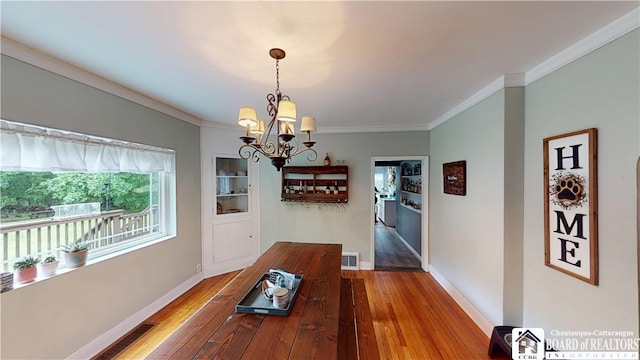 3108 N Main Street Ext, Ellicott, NY 14701 - dining area with a chandelier, ornamental molding, hardwood / wood-style floors, and baseboards