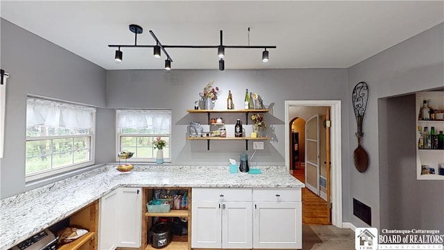 3108 N Main Street Ext, Ellicott, NY 14701 - kitchen with open shelves, white cabinetry, light wood-type flooring, light stone countertops, and track lighting