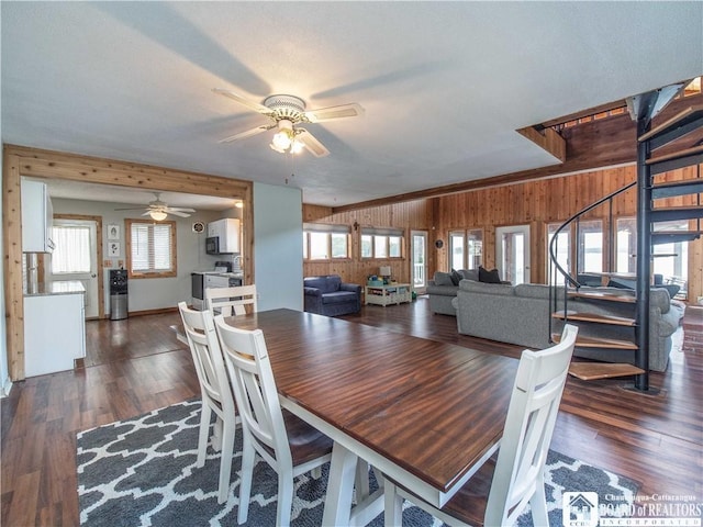 3973 Rte 430, Ellery, NY 14712 - dining area with wood walls, a ceiling fan, dark wood-style flooring, and stairway