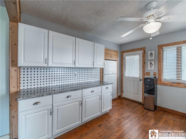 3973 Rte 430, Ellery, NY 14712 - kitchen featuring dark wood finished floors, white cabinets, ceiling fan, stone countertops, and freestanding refrigerator
