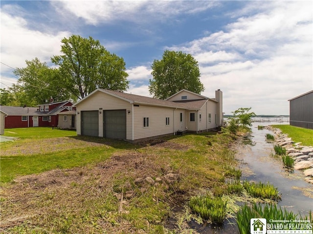 3973 Rte 430, Ellery, NY 14712 - view of home's exterior featuring a garage, a yard, driveway, and a chimney