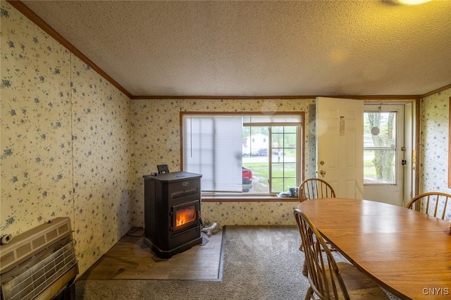 1572 County Route 6, Volney, NY 13069 - carpeted dining space featuring a wood stove, wallpapered walls, crown molding, a textured ceiling, and healthy amount of natural light