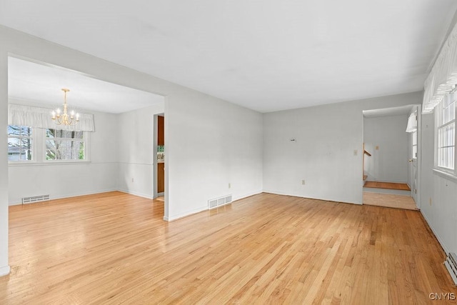 4155 Old Winding Way, Onondaga, NY 13215 - spare room with a chandelier, light wood-style floors, plenty of natural light, and stairway