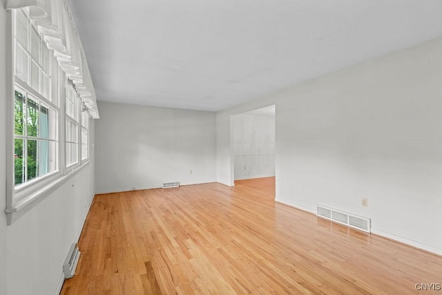 4155 Old Winding Way, Onondaga, NY 13215 - spare room with light wood-type flooring, a baseboard radiator, and baseboards