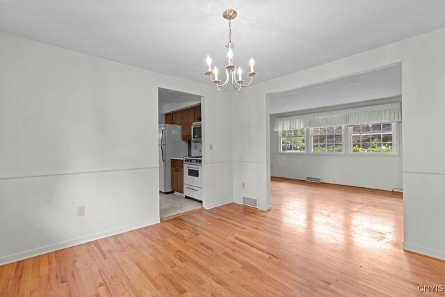 4155 Old Winding Way, Onondaga, NY 13215 - empty room with a chandelier, light wood finished floors, and baseboards
