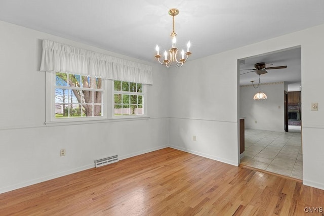 4155 Old Winding Way, Onondaga, NY 13215 - empty room featuring a chandelier, ceiling fan, baseboards, and light wood-style flooring