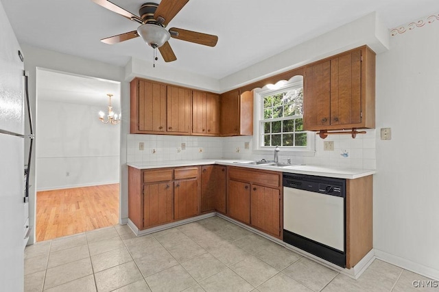 4155 Old Winding Way, Onondaga, NY 13215 - kitchen featuring white dishwasher, a sink, brown cabinets, and light countertops