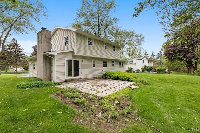4155 Old Winding Way, Onondaga, NY 13215 - back of property with a chimney, a patio area, and a yard