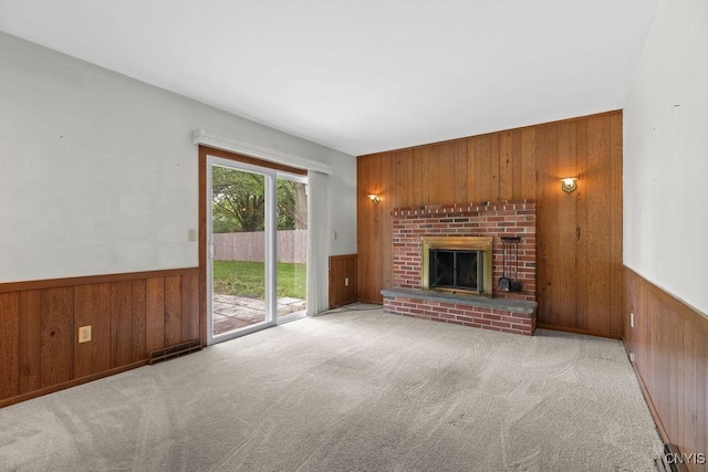 4155 Old Winding Way, Onondaga, NY 13215 - unfurnished living room with wood walls, carpet floors, a brick fireplace, and wainscoting