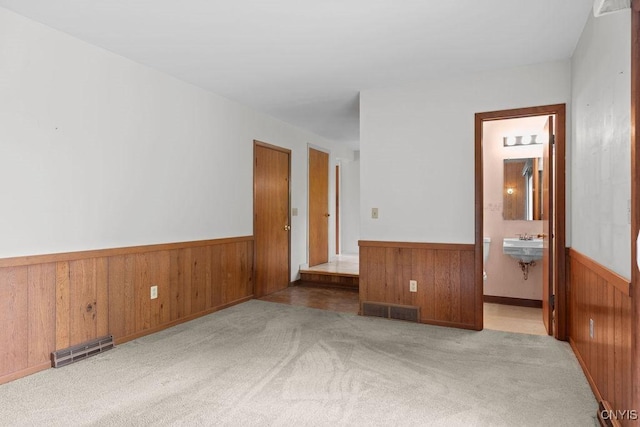 4155 Old Winding Way, Onondaga, NY 13215 - empty room featuring wood walls, a wainscoted wall, and carpet floors