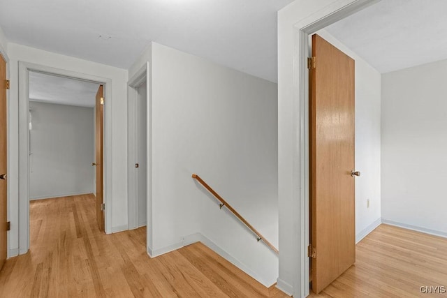 4155 Old Winding Way, Onondaga, NY 13215 - hall with an upstairs landing, light wood-type flooring, and baseboards