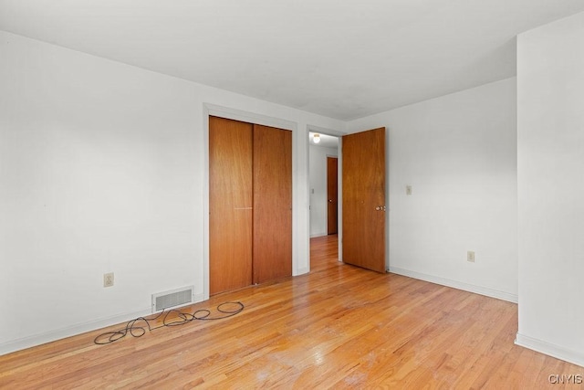 4155 Old Winding Way, Onondaga, NY 13215 - unfurnished bedroom with light wood-type flooring, a closet, and baseboards