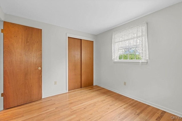 4155 Old Winding Way, Onondaga, NY 13215 - unfurnished bedroom with wood finished floors, baseboards, and a closet