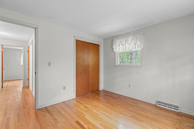 4155 Old Winding Way, Onondaga, NY 13215 - unfurnished bedroom with light wood-style flooring, a closet, and baseboards