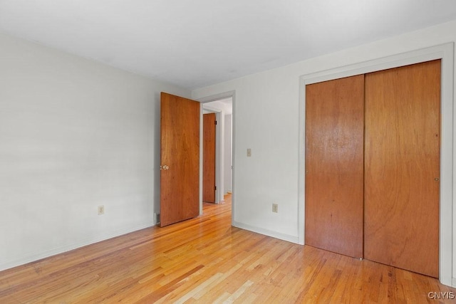 4155 Old Winding Way, Onondaga, NY 13215 - unfurnished bedroom featuring light wood-style floors, a closet, and baseboards